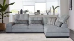 Cube corner sofa in grey fabric, in a bright living room with natural light
